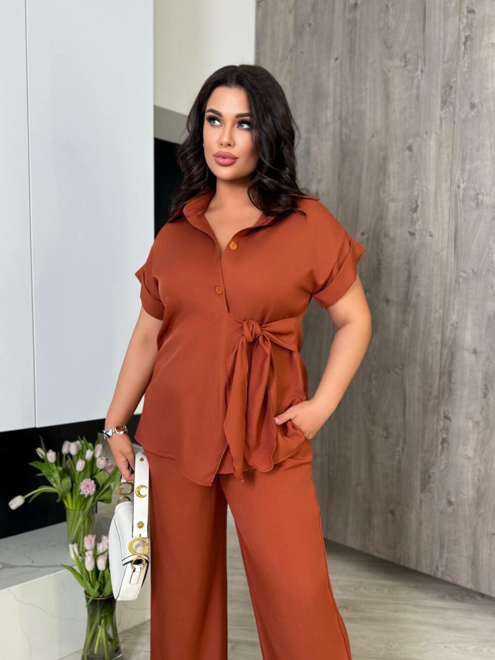 Костюм складається з брюк та блузи оригінального крою, колір теракот.